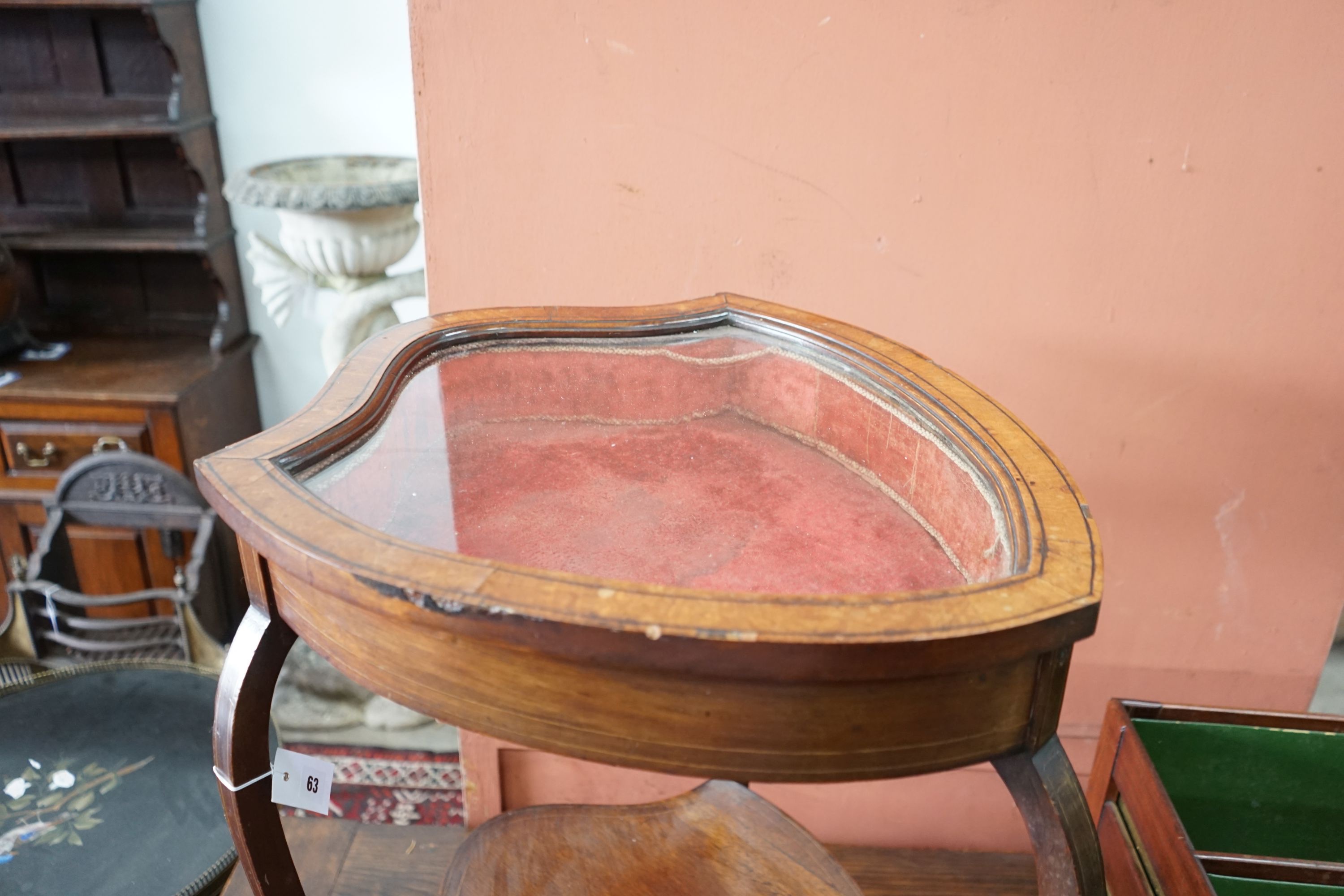 An Edwardian mahogany shield shaped bijouterie table, width 50cm, depth 59cm, height 72cm